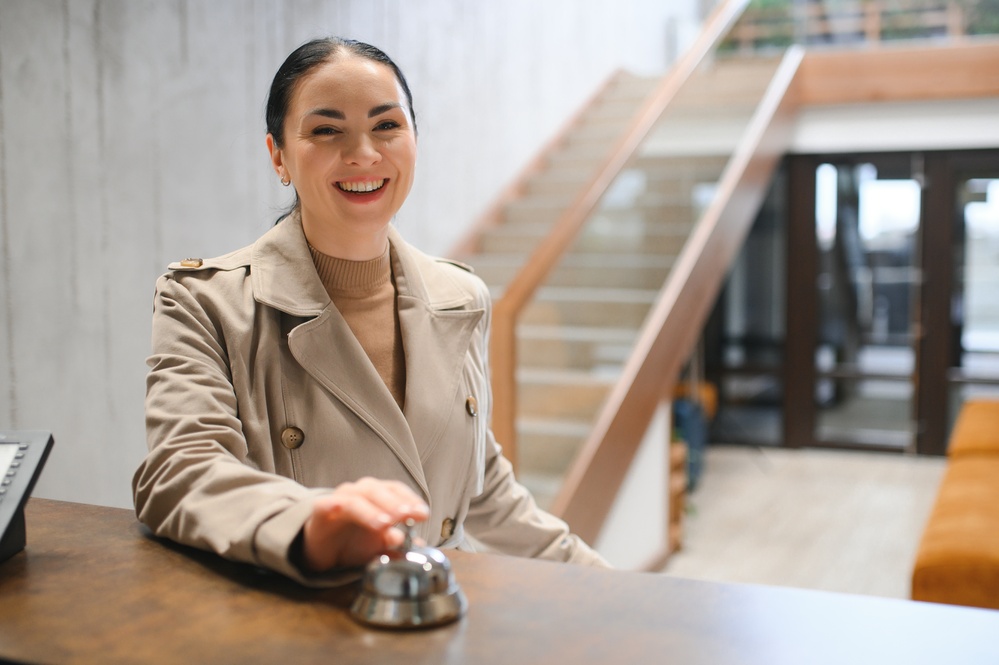 Elegant Business Woman with Travel Trolley Luggage in Hotel Lobby